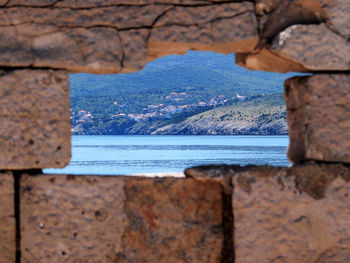 Scenic view of sea seen through rocks