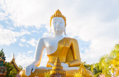 Low angle view of statue against temple against sky