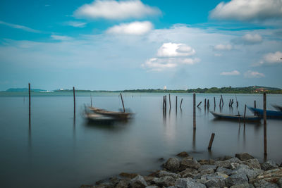 Sailboats in sea against sky