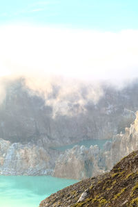 Scenic view of sea and mountains against sky