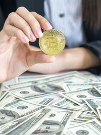 Close-up of hand holding coins