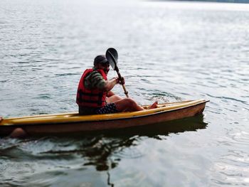 Man sitting in boat on sea