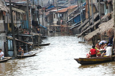 Boats in canal along buildings