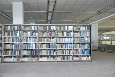 Stack of books on bookshelves in library