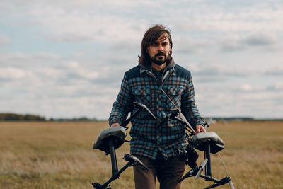 Young man riding bicycle on field