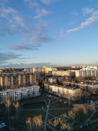 High angle view of townscape by river against sky