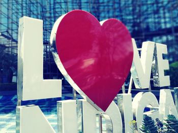 Close-up of heart shape on table by swimming pool