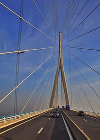 Low angle view of suspension bridge against sky