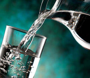 Close-up of glass pouring water