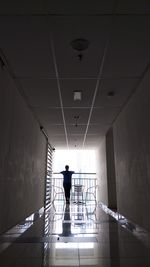 Full length rear view of man walking in building