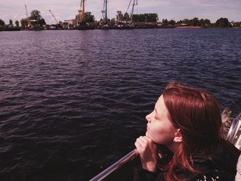 Portrait of woman looking at sea against sky