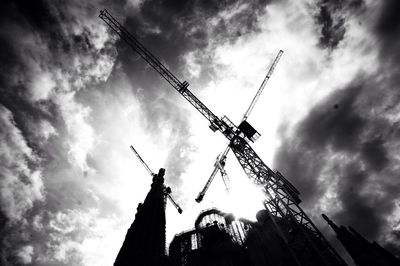 Low angle view of crane against sky