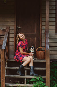 Woman with dog sitting on seat