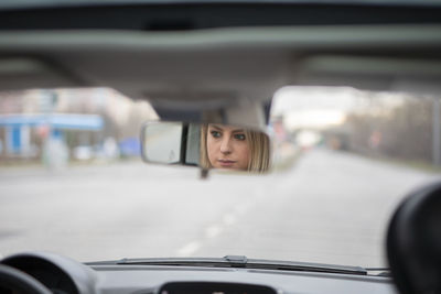 Portrait of young woman in car