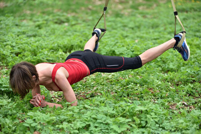 Mid adult woman exercising at public park