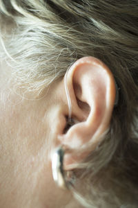 Close-up of woman with hearing aid