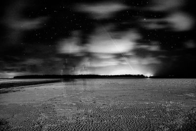 Scenic view of field against sky at night