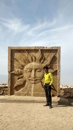 Rear view of man standing against the sky