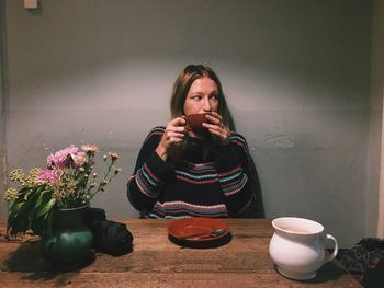 Young woman sitting with flowers