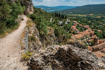 View of stone path above roofs and belfry at moustiers-sainte-marie, in the french provence.