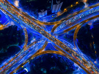 Aerial view of light trails on elevated road in city at night