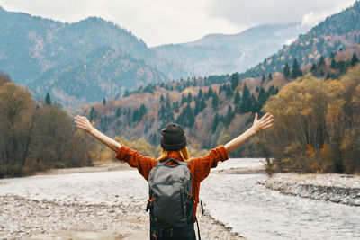 Rear view of man standing on mountain