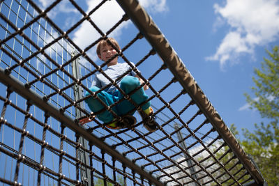 Low angle view of boy against sky