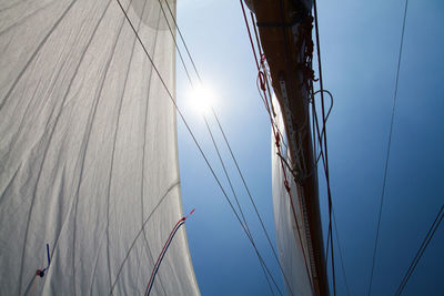 Low angle view of mast against sky on sunny day