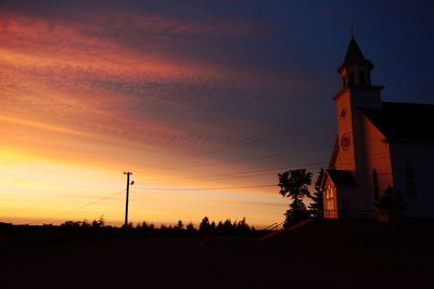 Low angle view of silhouette building against sky during sunset