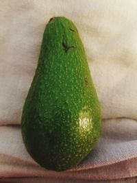 Close-up of green fruit on table