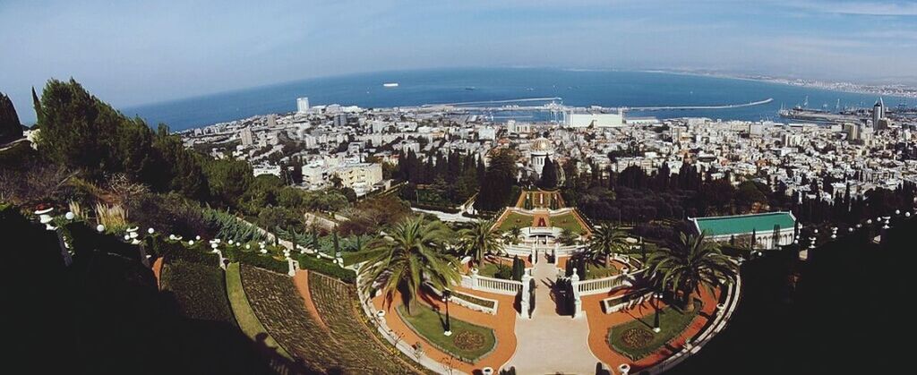 architecture, tree, built structure, high angle view, building exterior, sea, illuminated, sky, water, city, travel destinations, cityscape, tourism, travel, nature, crowded, palm tree, scenics, outdoors, famous place