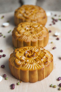 High angle view of moon cakes arranged with seeds on cutting board