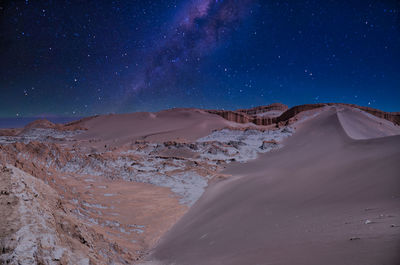 Scenic view of desert against sky at night