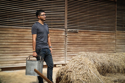 Full length of man working on hay