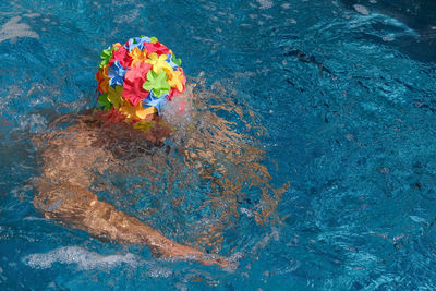 High angle view of man wearing swimming cap in pool