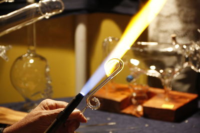 Cropped hand of male worker preparing glass at workshop