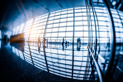 Silhouette people walking in modern building