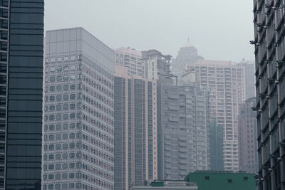 Modern buildings in city against clear sky