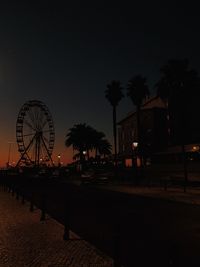 Silhouette ferris wheel against sky at night