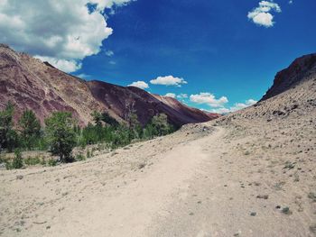Scenic view of mountains against blue sky