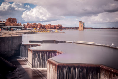View of bridge over sea against cloudy sky