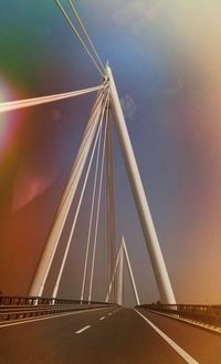 Low angle view of suspension bridge against sky