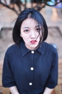 High angle portrait of young woman standing outdoors