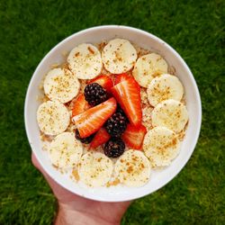 Cropped hand holding breakfast