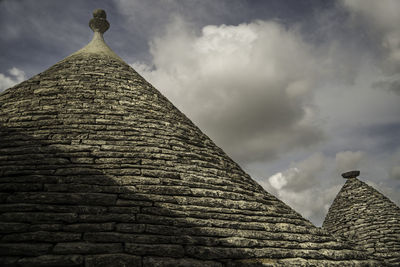Low angle view of trulli house in alberobello against sky