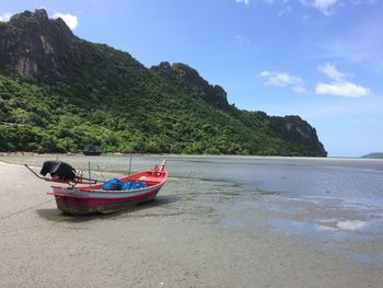 Boat on beach against sky
