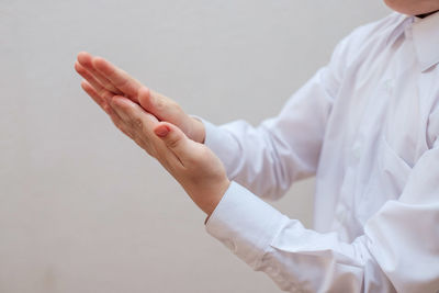 Midsection of woman against white background