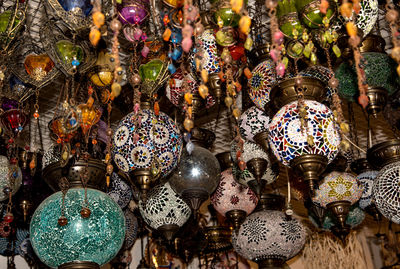 Close-up of electric lamp hanging at market stall