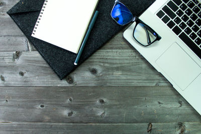 High angle view of laptop and book on table