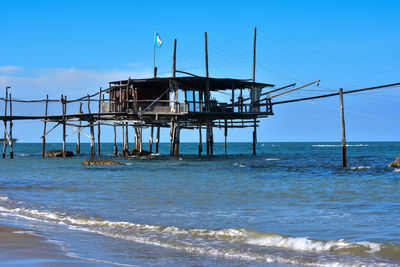 Lifeguard hut on beach against sky